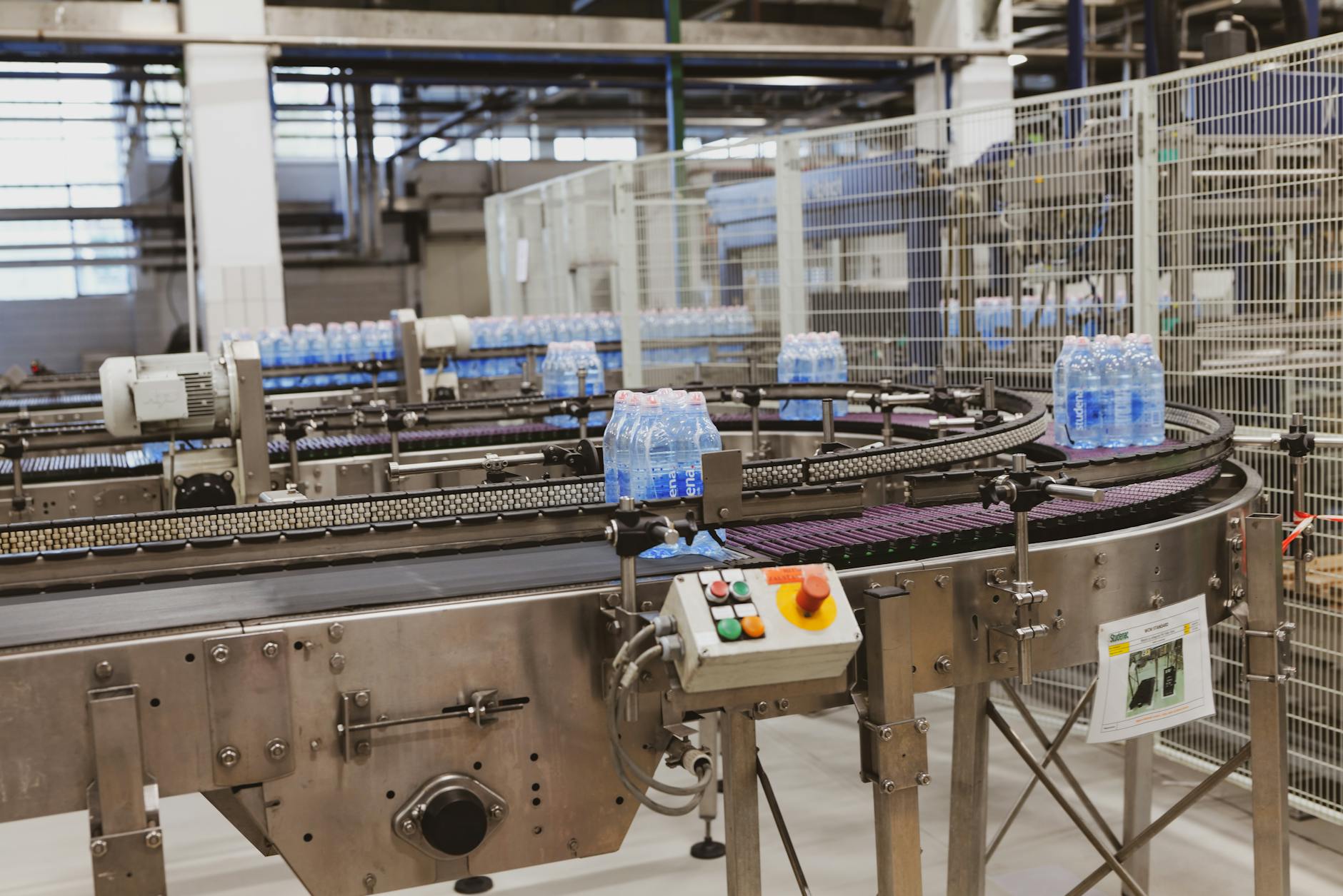 Butelki z wodą na zautomatyzowanej linii pakującej w fabryce